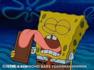 Spongebob Squarepants Is Holding A Chocolate Bar With His Tongue Out . GIF