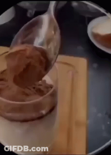 Spoon Pouring Chocolate Mousse Into Cup GIF