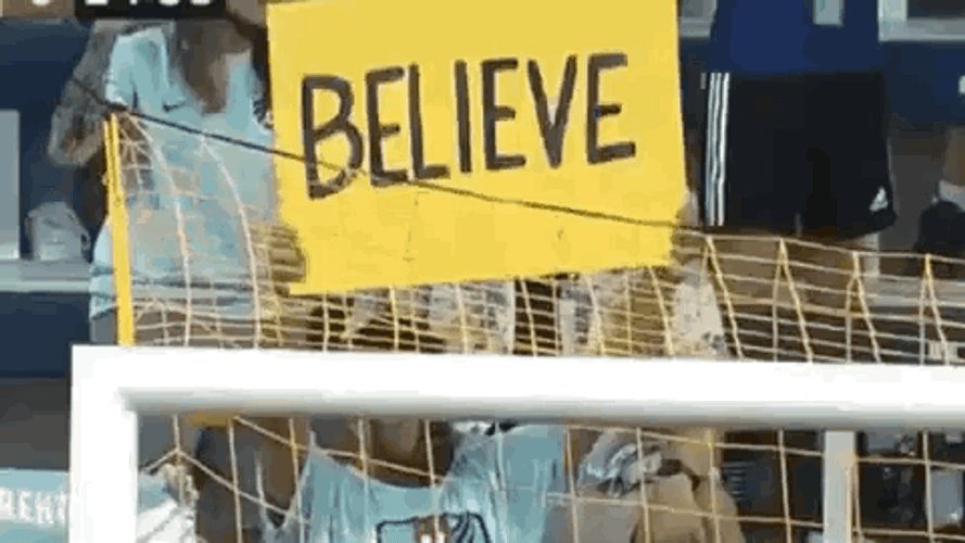 Sports Fan Raising Ted Lasso Believe Sign GIF