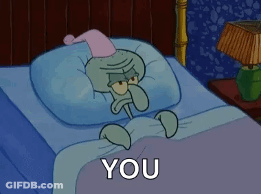 Squidward From Spongebob Squarepants Is Laying In A Bed With A Pillow And A Nightcap On . GIF