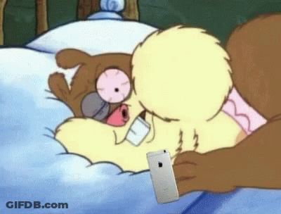Squirrel In Bed With Phone In Mouth GIF