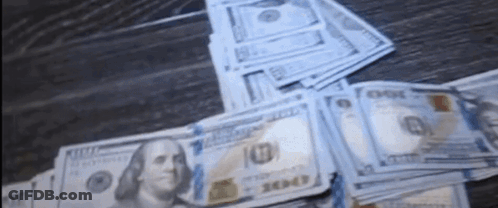 Stack Of Hundred Dollar Bills On Wooden Table GIF