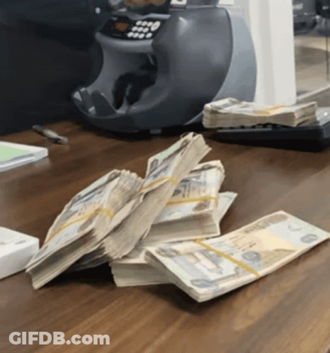 Stack Of Money Next To Machine Saying 0000 GIF