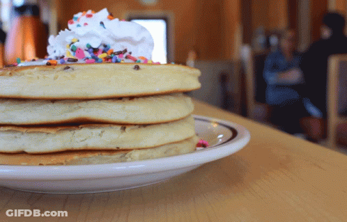 Stack Of Pancakes With Whipped Cream And Sprinkles GIF