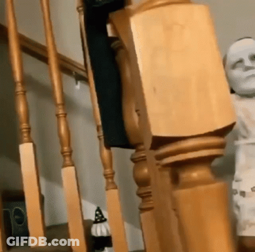 Staircase With Wooden Railing And Mummy Statue GIF