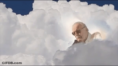 Stan Lee Laying In Clouds With Light Coming Out Of Head GIF