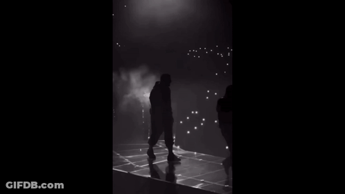 Standing Silhouette On Stage In Dark GIF