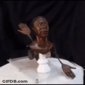Statue Of A Man's Head On A Table GIF