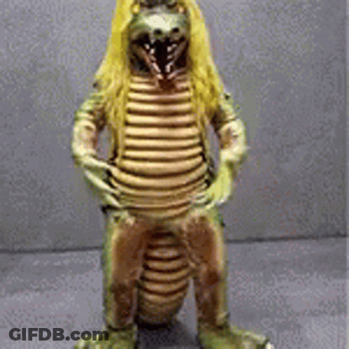 Statue Of Dinosaur With Long Blonde Hair GIF