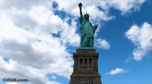 Statue Of Liberty In Front Of Blue Sky GIF