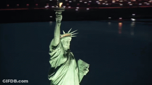 Statue Of Liberty Lit Up Holding Book Saying Just Do It GIF