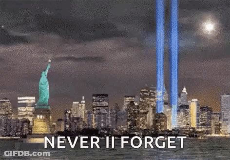 Statue Of Liberty Surrounded By City Skyline At Night Saying Never Ii Forget GIF