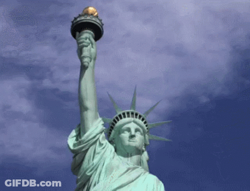 Statue Of Liberty With Man's Face Painted On It GIF