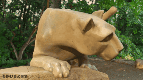 Statue Of Lioness Laying On Rock GIF