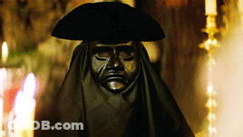Statue Of Man In Black Mask And Hat GIF