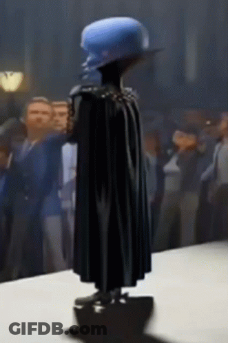 Statue Of Man In Cape And Blue Hat GIF