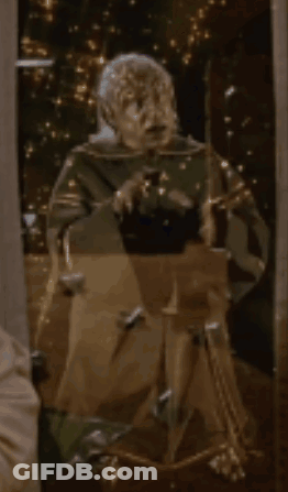Statue Of Man In Front Of Mirror With Lights GIF