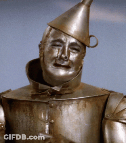 Statue Of Man In Tin Man Outfit GIF