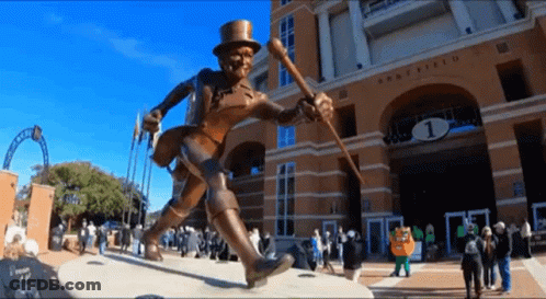 Statue Of Man In Top Hat And Cane In Front Of Army Field Building GIF
