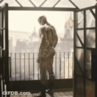 Statue Of Man On Balcony Looking Out Window GIF