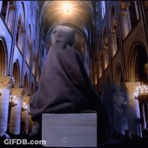 Statue Of Man Sitting On Box In Building GIF