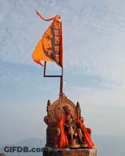 Statue Of Man Sitting On Throne With Flag GIF