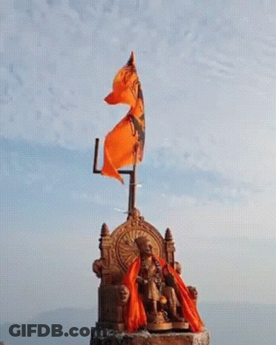 Statue Of Man Sitting On Throne With Orange Flag GIF