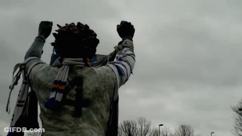 Statue Of Man With Scarf And Number 4 On Back GIF