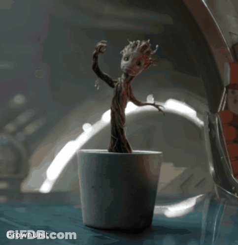 Statue Of Tree In Pot Saying Brown Unit GIF