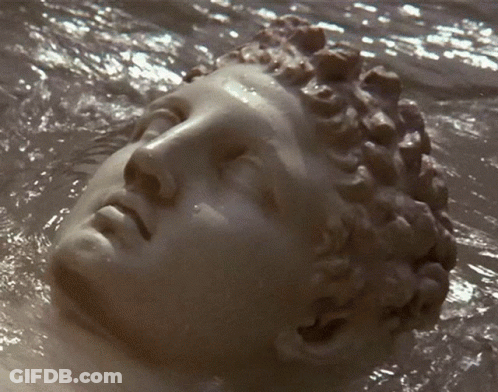 Statue Of Woman's Face Floating In Water GIF