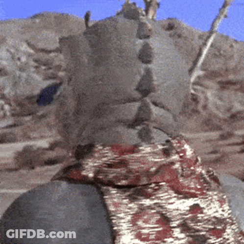 Statue With Scarf And Mountains GIF