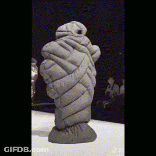 Statue Wrapped In Blanket Standing On Table GIF