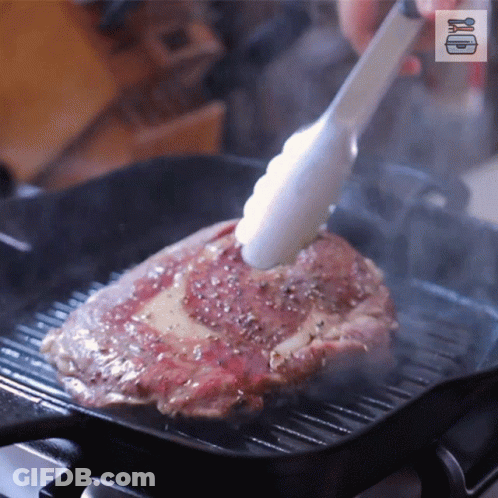 Steak Cooking On Grill With Tongs GIF