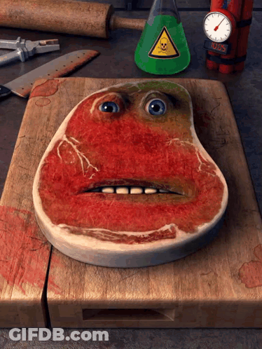 Steak With Face Painted On Wooden Cutting Board GIF