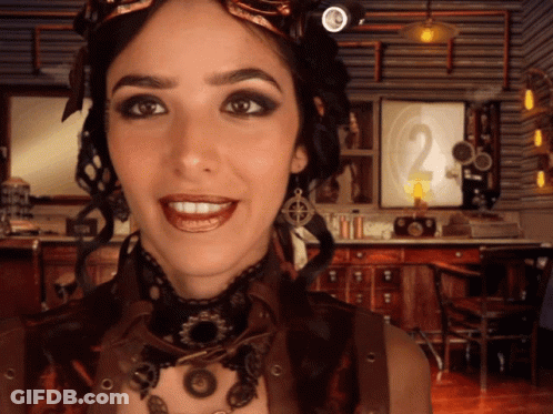 Steampunk Woman Smiling In Front Of Clock GIF