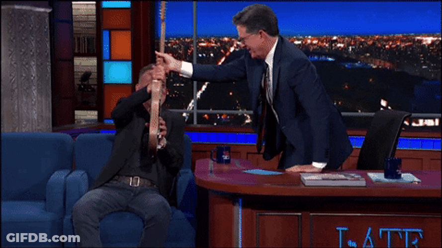 Stephen Colbert Getting Guitar From Bruce Springsteen GIF