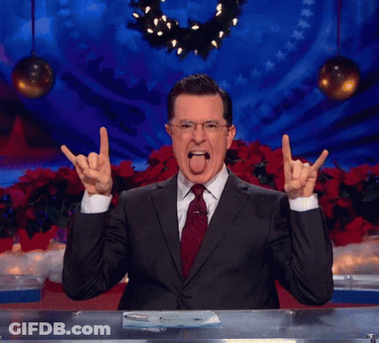 Stephen Colbert Making Hook Em Sign With Tongue Out GIF