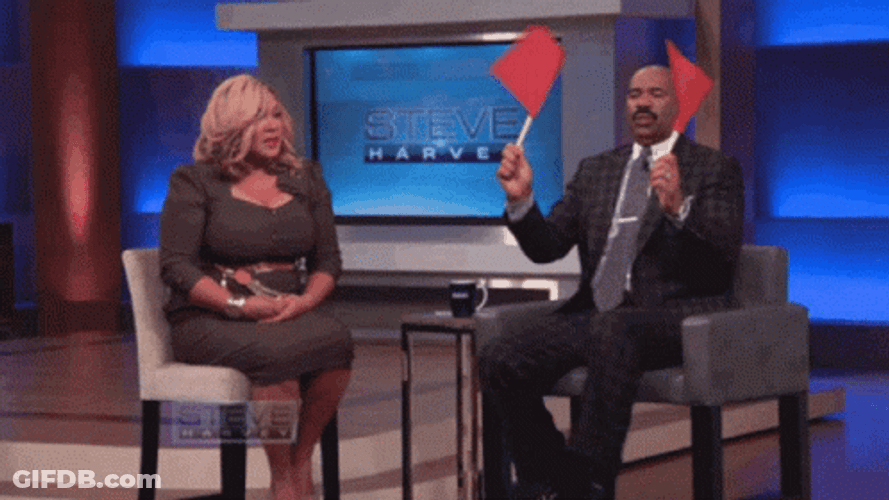 Steve Harvey Waves Two Red Flag GIF