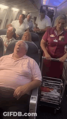 Stewardess Pushing Cart With Sleeping Man GIF