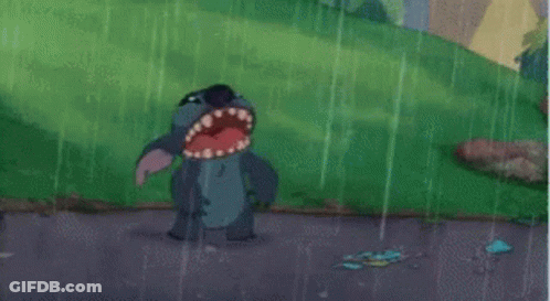 Stitch From Disney 'S Lilo And Stitch Is Standing In The Rain With His Mouth Open . GIF