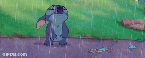 Stitch From Disney 'S Lilo And Stitch Is Standing In The Rain With His Mouth Wide Open . GIF
