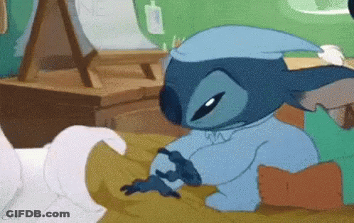 Stitch Laying On Bed Wearing Nightcap GIF