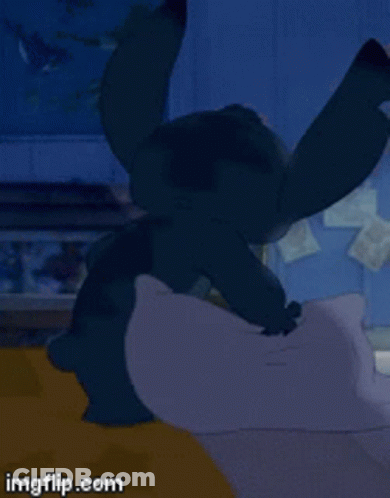 Stitch Laying On Bed With Pillow GIF