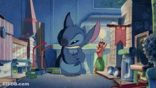 Stitch Standing In Front Of Coca Cola Building GIF