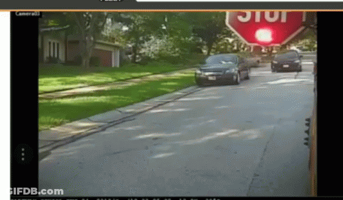 Stop Sign Above Street With Cars GIF