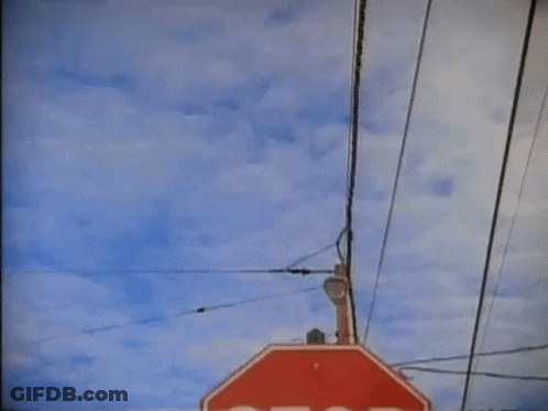 Stop Sign Hanging From Pole GIF