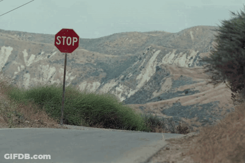 Stop Sign On Side Of Road GIF