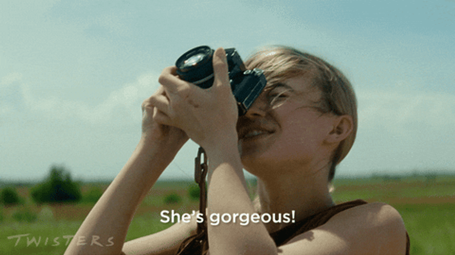Storm Chaser Kate Carter Taking Photograph GIF
