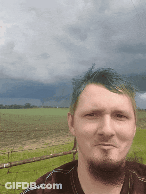 Storm Chaser Taking Video With Dark Clouds GIF