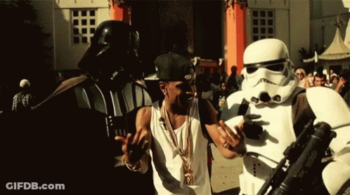 Stormtrooper Man Next To Darth Vader Costume GIF